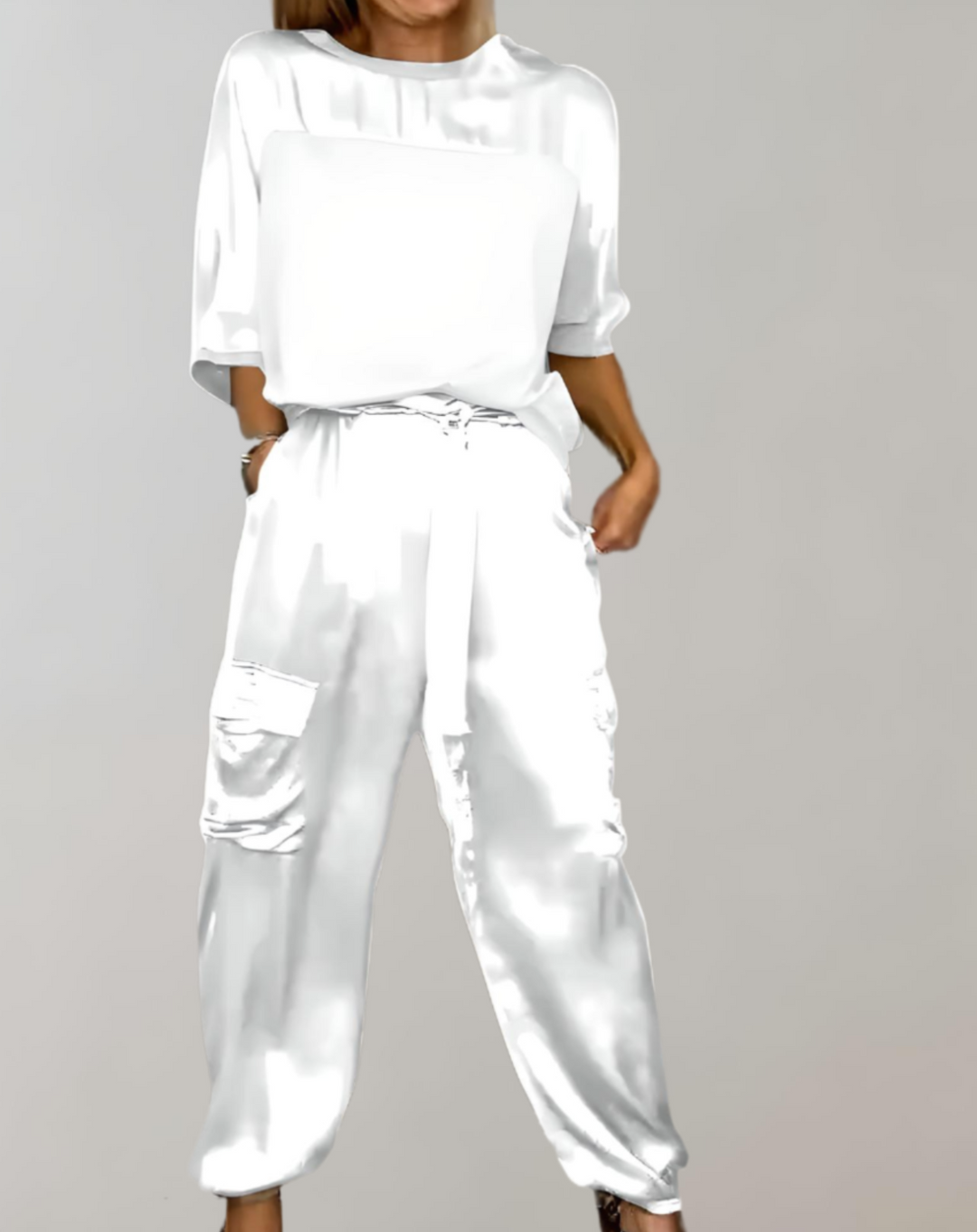 A woman wearing a silky-finish cargo top and pants lounge set with pockets.