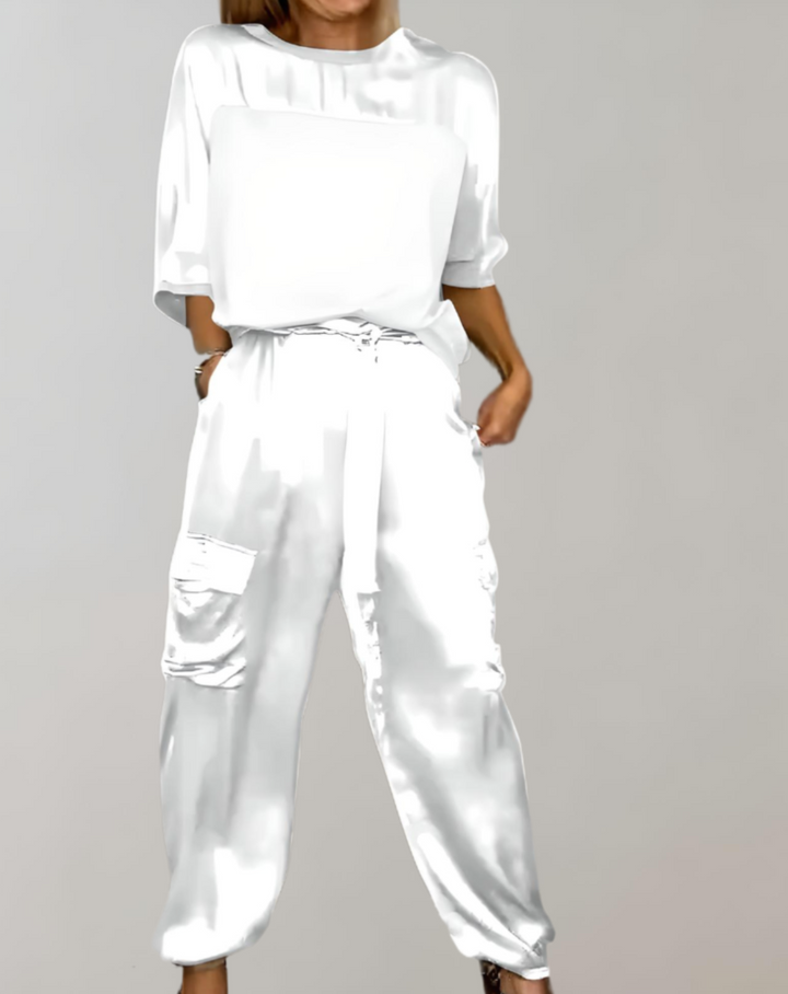A woman wearing a silky-finish cargo top and pants lounge set with pockets.