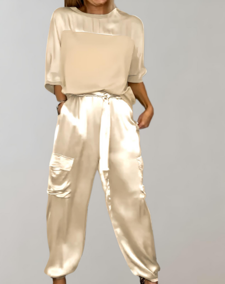 A woman wearing a silky-finish cargo top and pants lounge set with pockets.