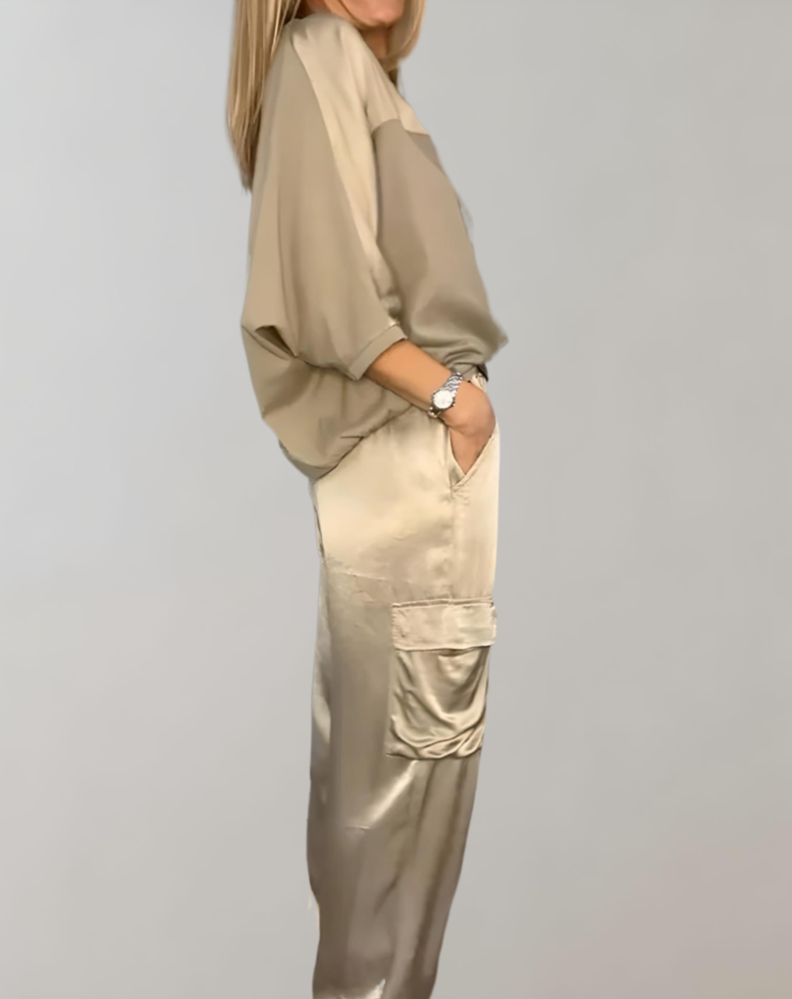 A woman wearing a silky-finish cargo top and pants lounge set with pockets.