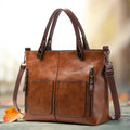 A woman holding a versatile classic handbag with a rich finish by her side
