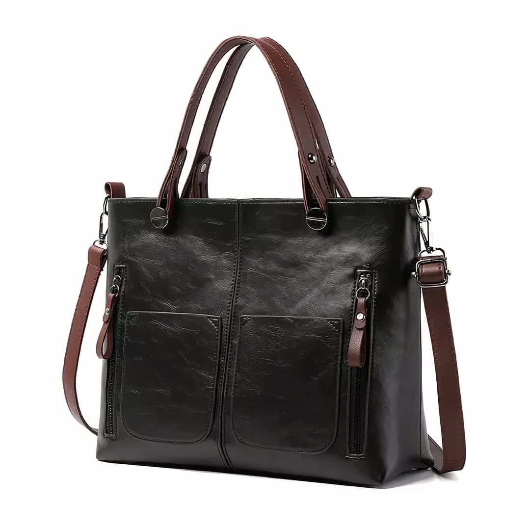 A woman holding a versatile classic handbag with a rich finish by her side