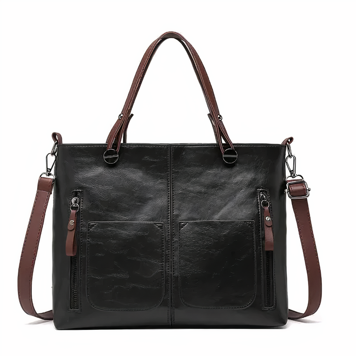 A woman holding a versatile classic handbag with a rich finish by her side