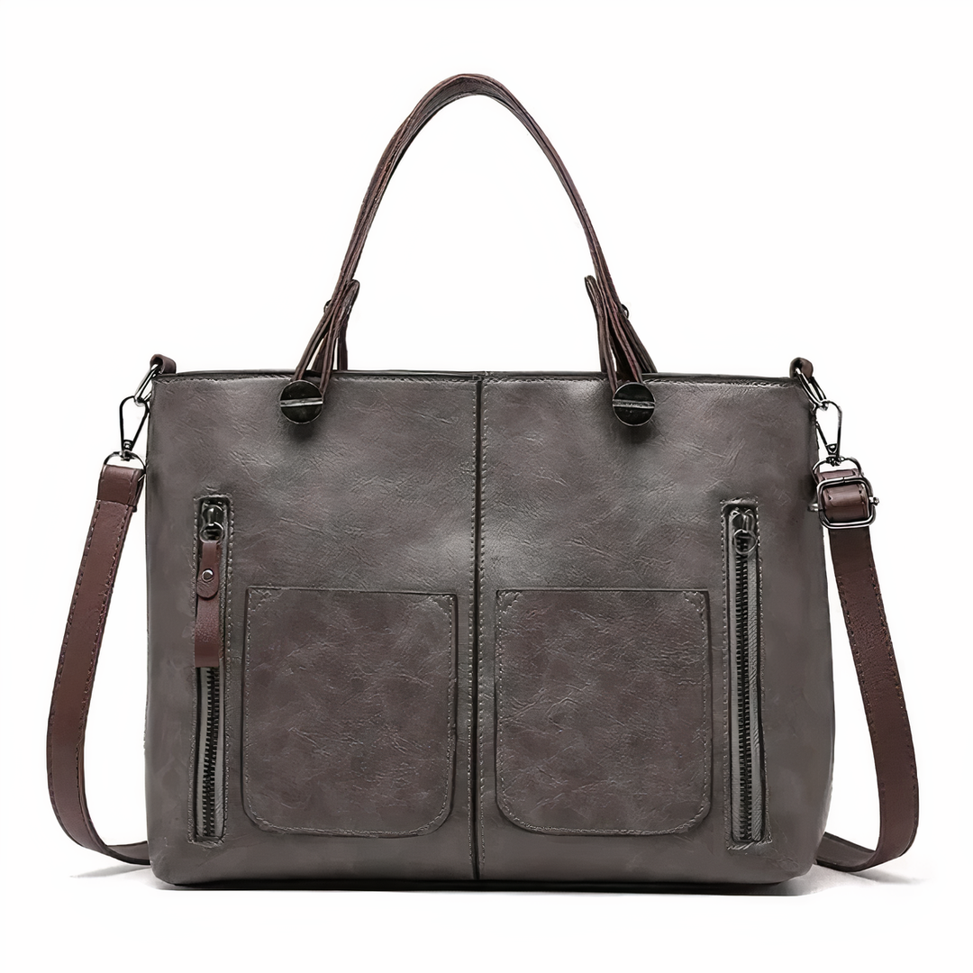 A woman holding a versatile classic handbag with a rich finish by her side