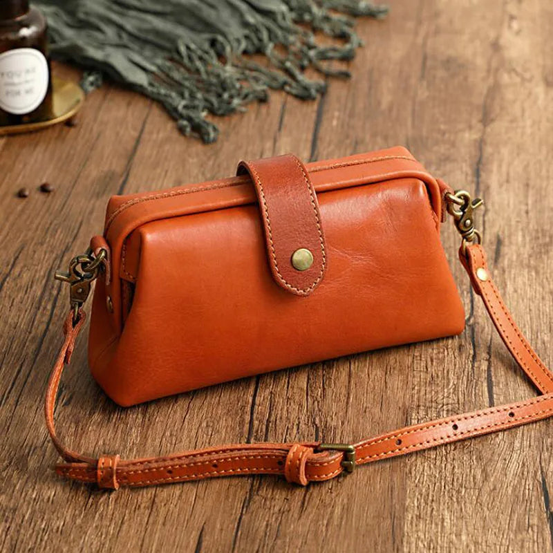 A woman carrying a trendy shoulder bag with a rich finish over one shoulder