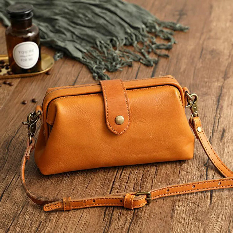 A woman carrying a trendy shoulder bag with a rich finish over one shoulder