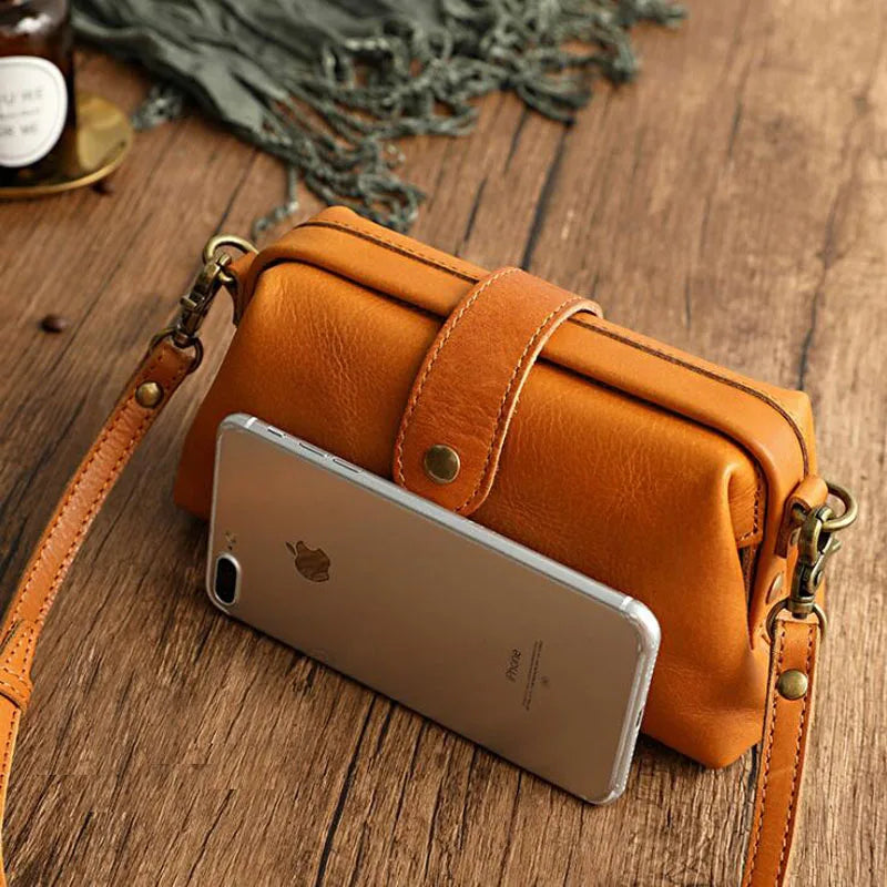 A woman carrying a trendy shoulder bag with a rich finish over one shoulder