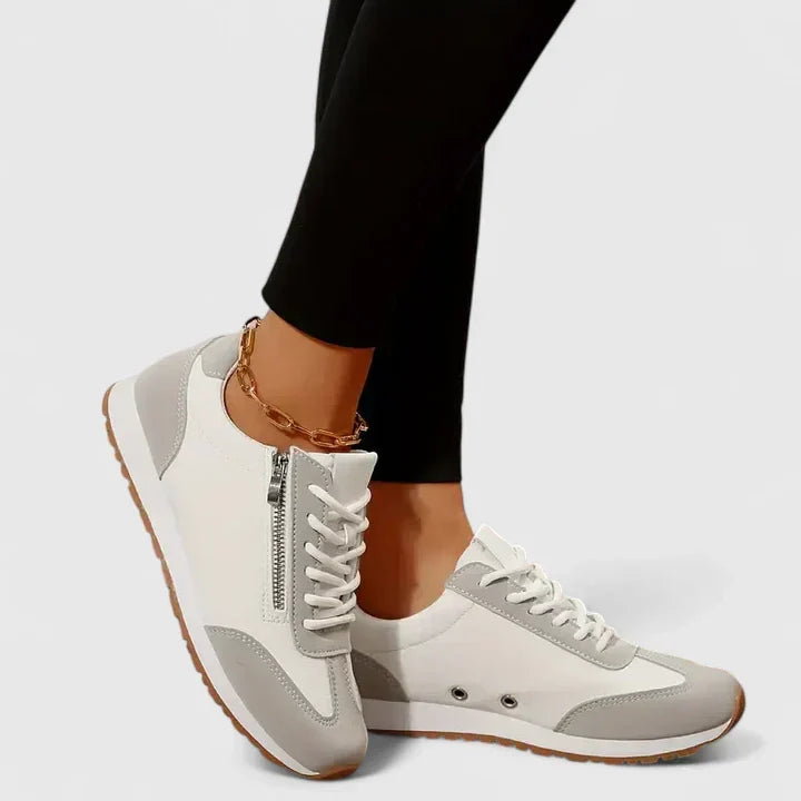 A woman wearing orthopaedic shoes with a supportive heel and a subtle lift