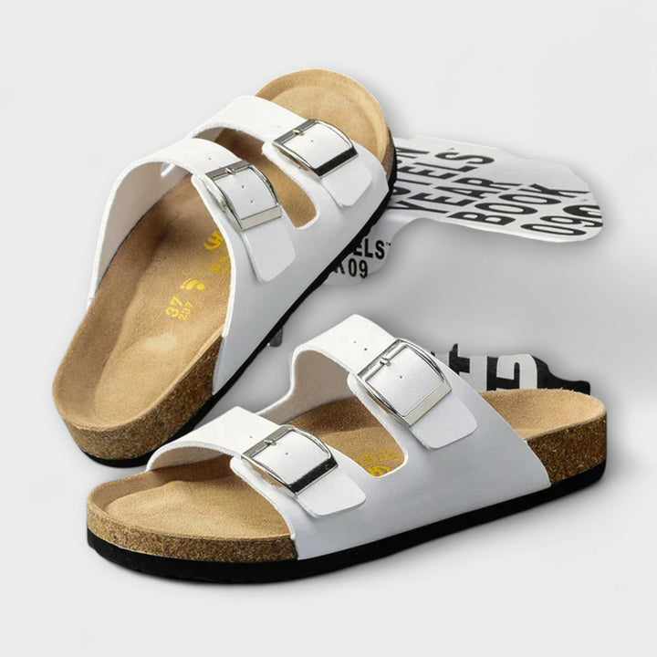 A woman strolling in the sunshine wearing supportive, cushioned everyday comfort sandals.