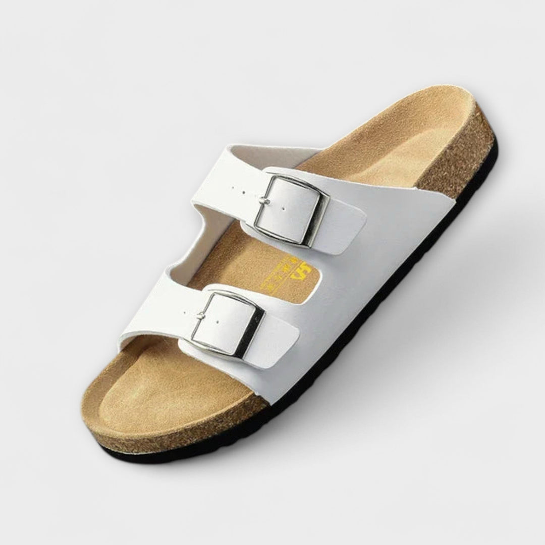 A woman strolling in the sunshine wearing supportive, cushioned everyday comfort sandals.