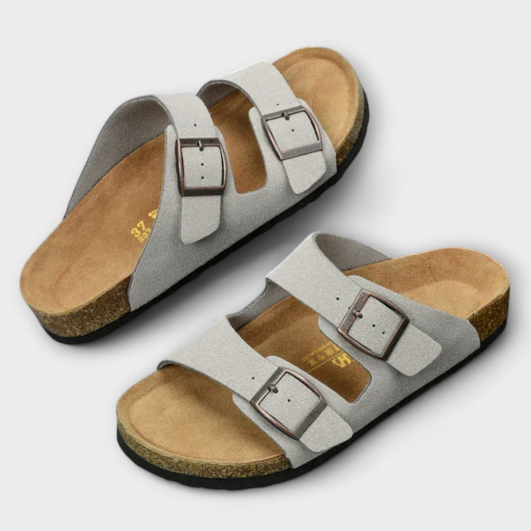 A woman strolling in the sunshine wearing supportive, cushioned everyday comfort sandals.