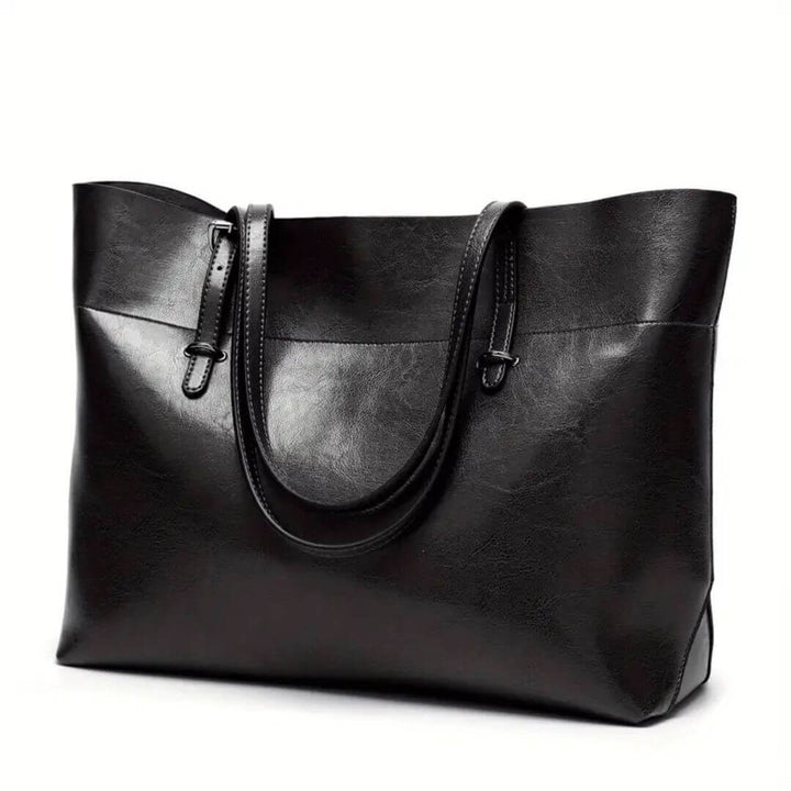 A woman carrying an elegant everyday handbag on her arm while out in town.