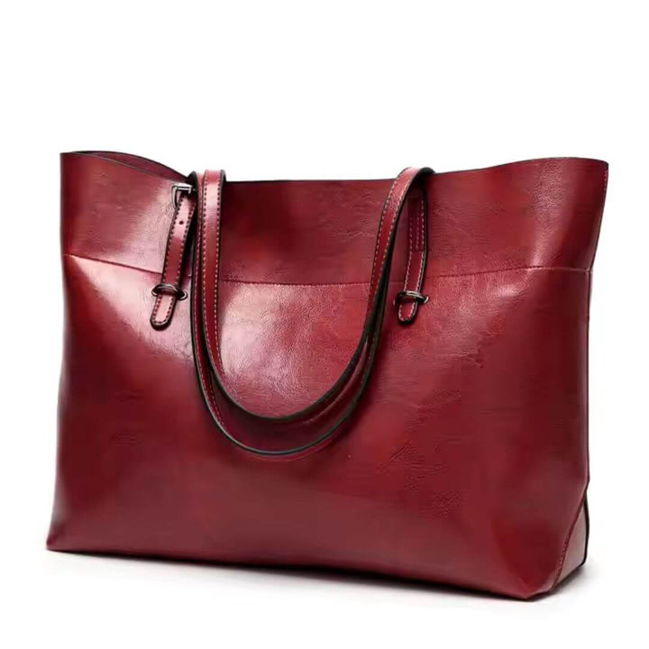 A woman carrying an elegant everyday handbag on her arm while out in town.