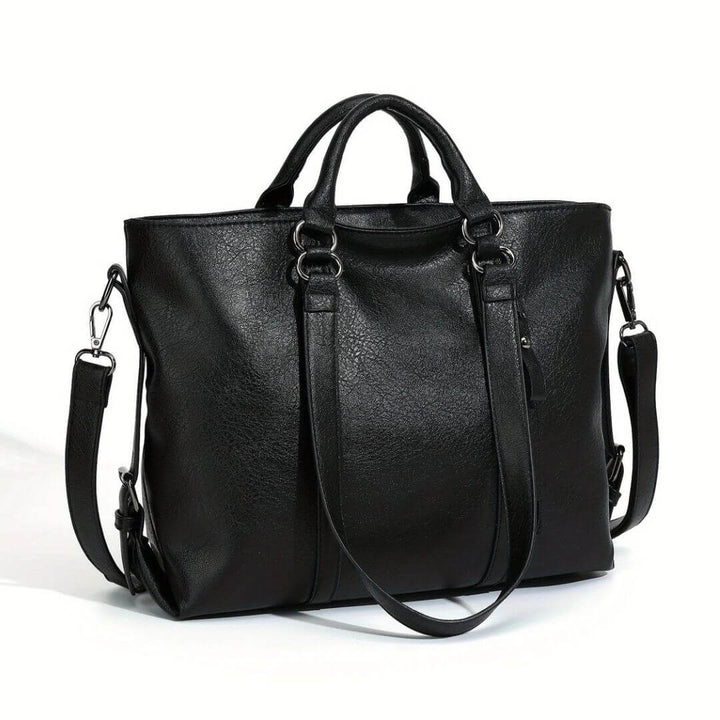 A woman carrying a roomy everyday tote bag on her shoulder while out for coffee in town.
