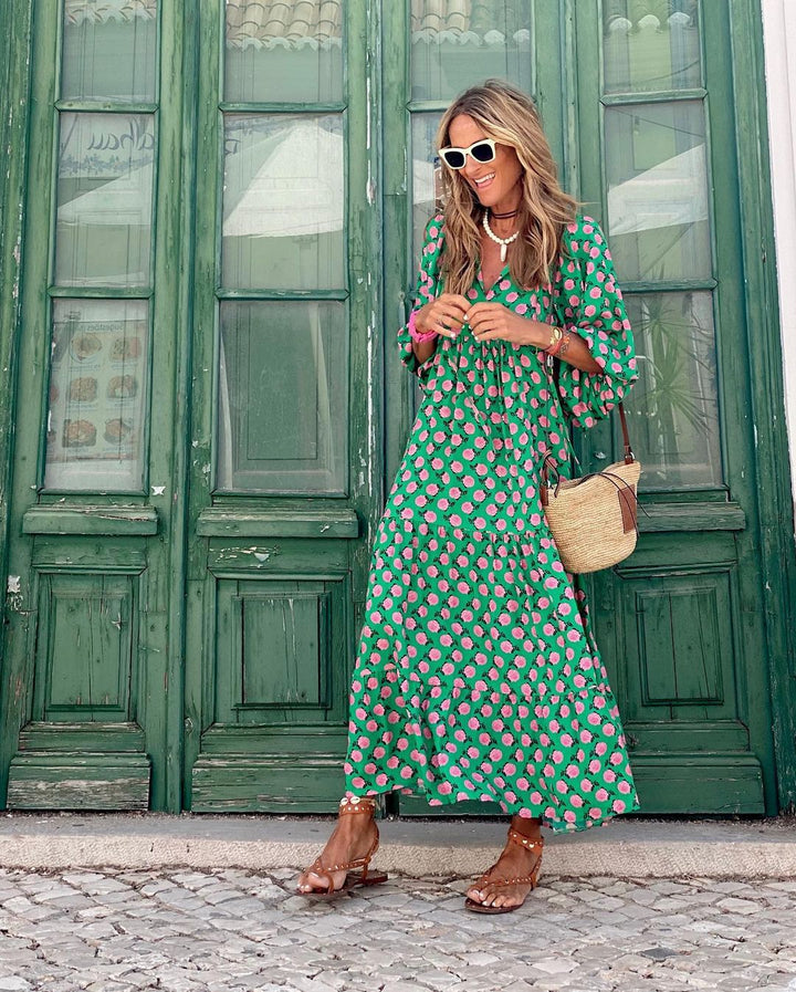 A woman wearing the Erin spring print dress in green and pink tones, styled for a day out.