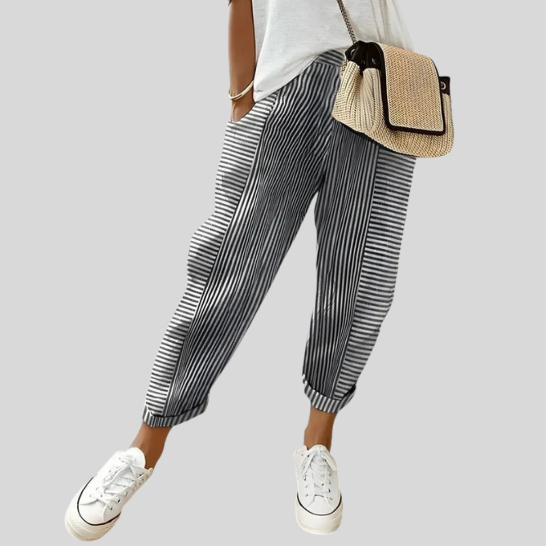 A woman wearing airy comfy summer pants with an elastic waist and side pockets.