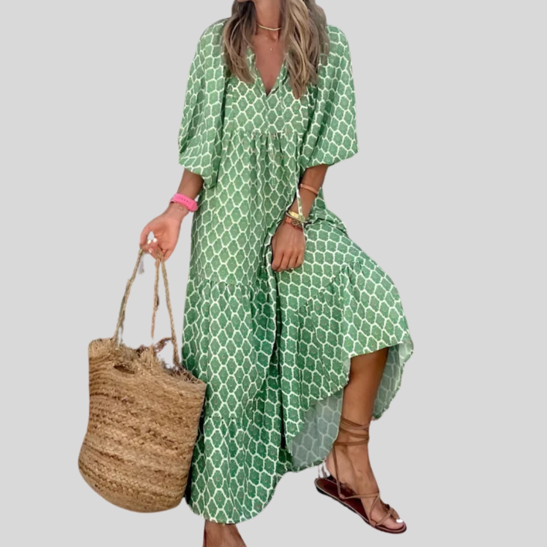 A woman wearing the Erin spring print dress in green and pink tones, styled for a day out.