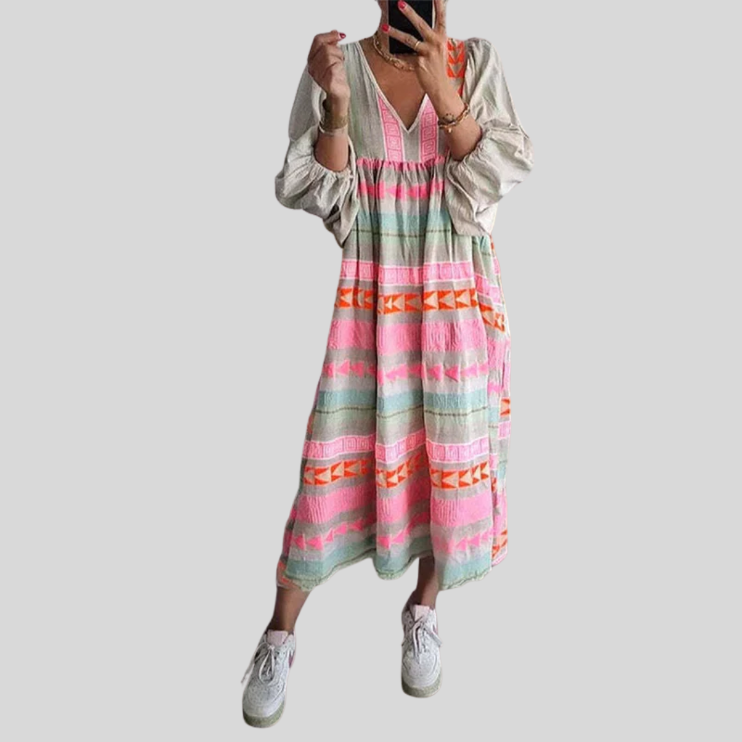 Woman wearing the Holly™ colourful geometric print boho dress with puffed sleeves, out enjoying a casual day.
