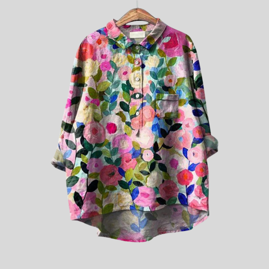 Woman wearing a flowing summer blouse with an elegant all-over print.