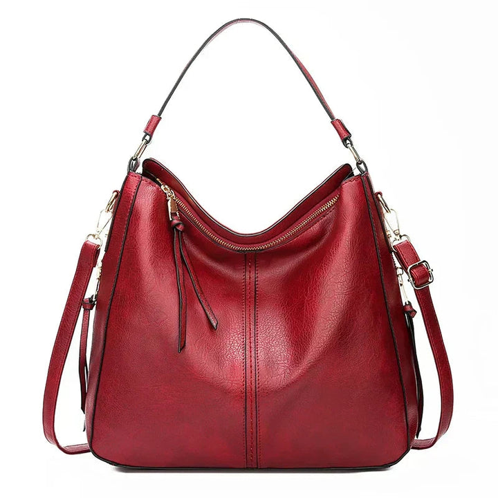A woman holding a timeless classic handbag with a rich finish by her side