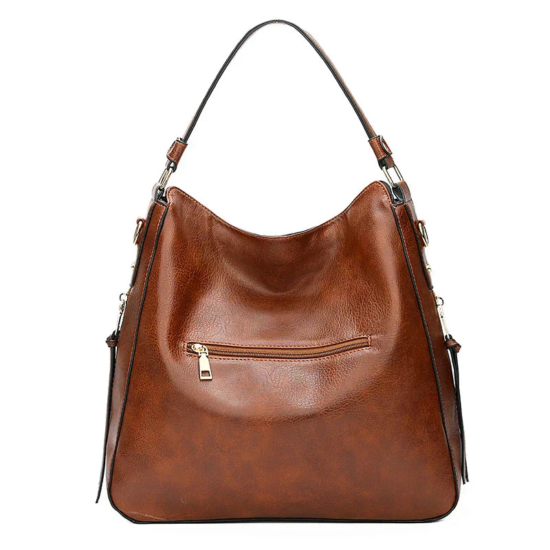 A woman holding a timeless classic handbag with a rich finish by her side