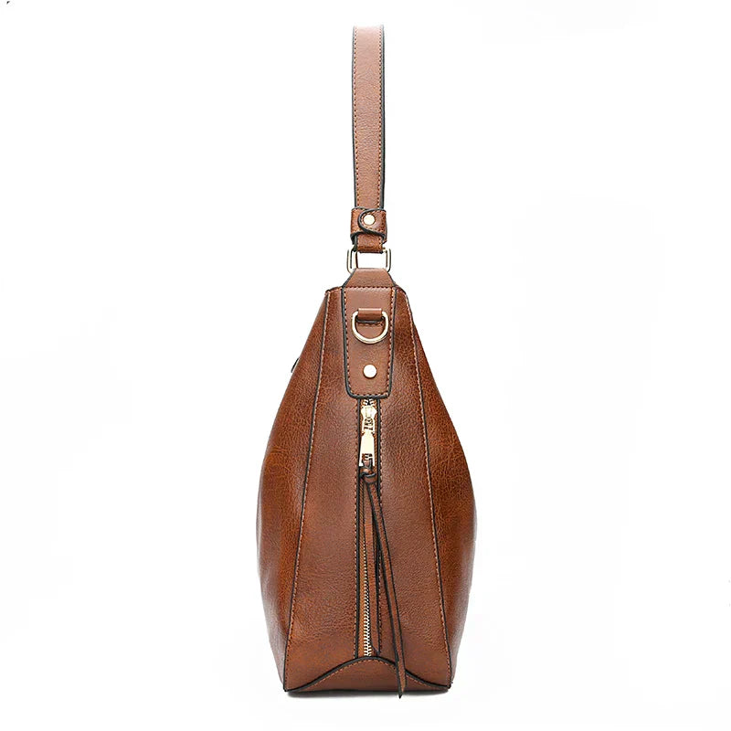 A woman holding a timeless classic handbag with a rich finish by her side