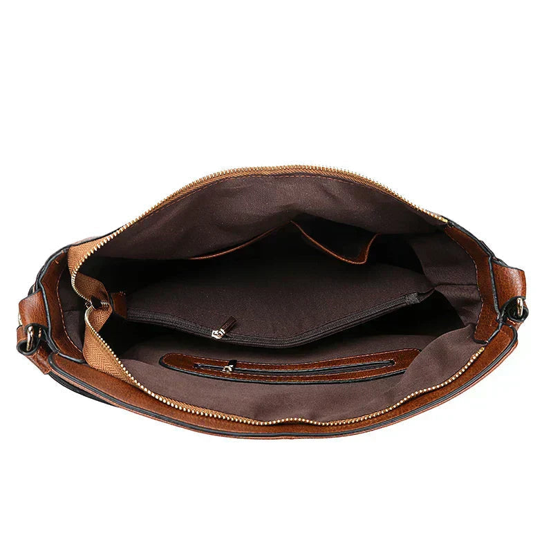 A woman holding a timeless classic handbag with a rich finish by her side