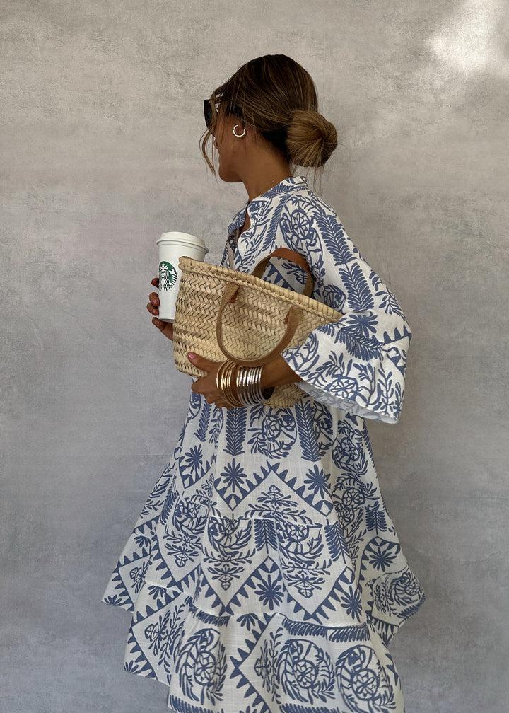 Woman wearing the Elaine button-front boho tunic dress, relaxed on a casual day out.