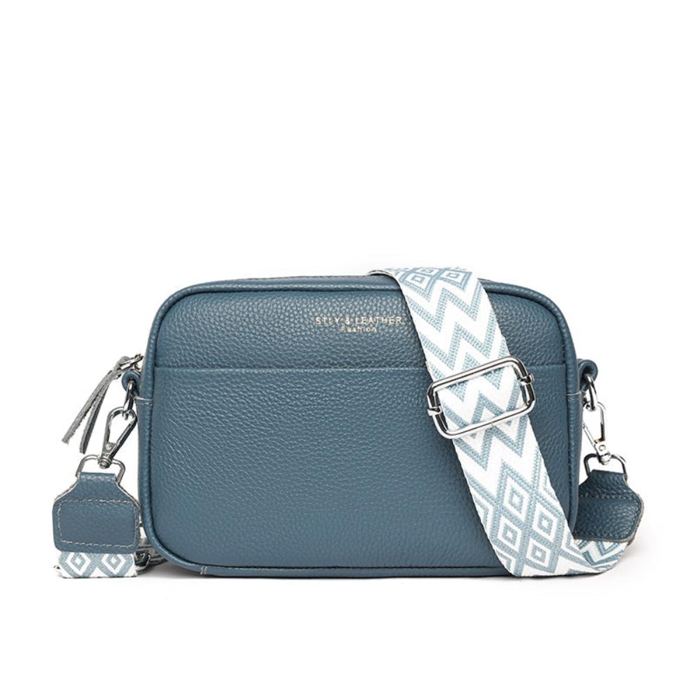 A woman wearing a timeless cross-body bag across her body while out and about