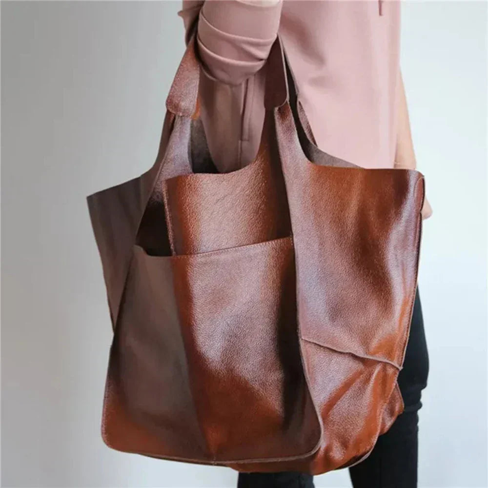 A woman carrying a vintage-style bag with a rich finish on a day out