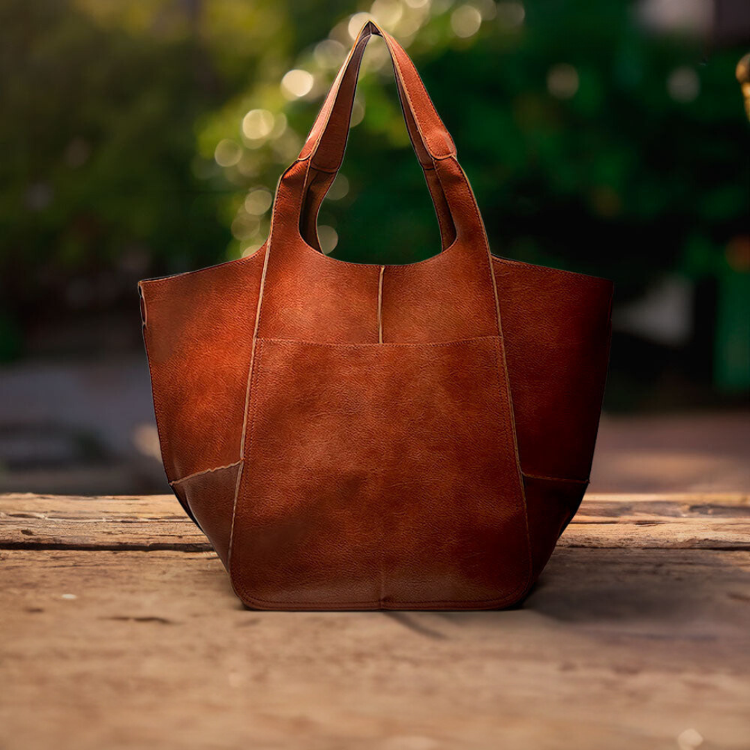 A woman carrying a vintage-style bag with a rich finish on a day out