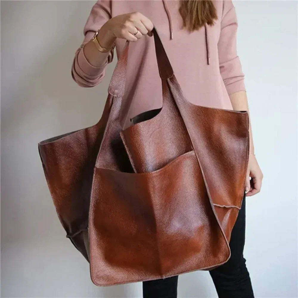 A woman carrying a vintage-style bag with a rich finish on a day out