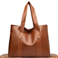 A woman carrying a classic elegant bag with a rich finish over her shoulder