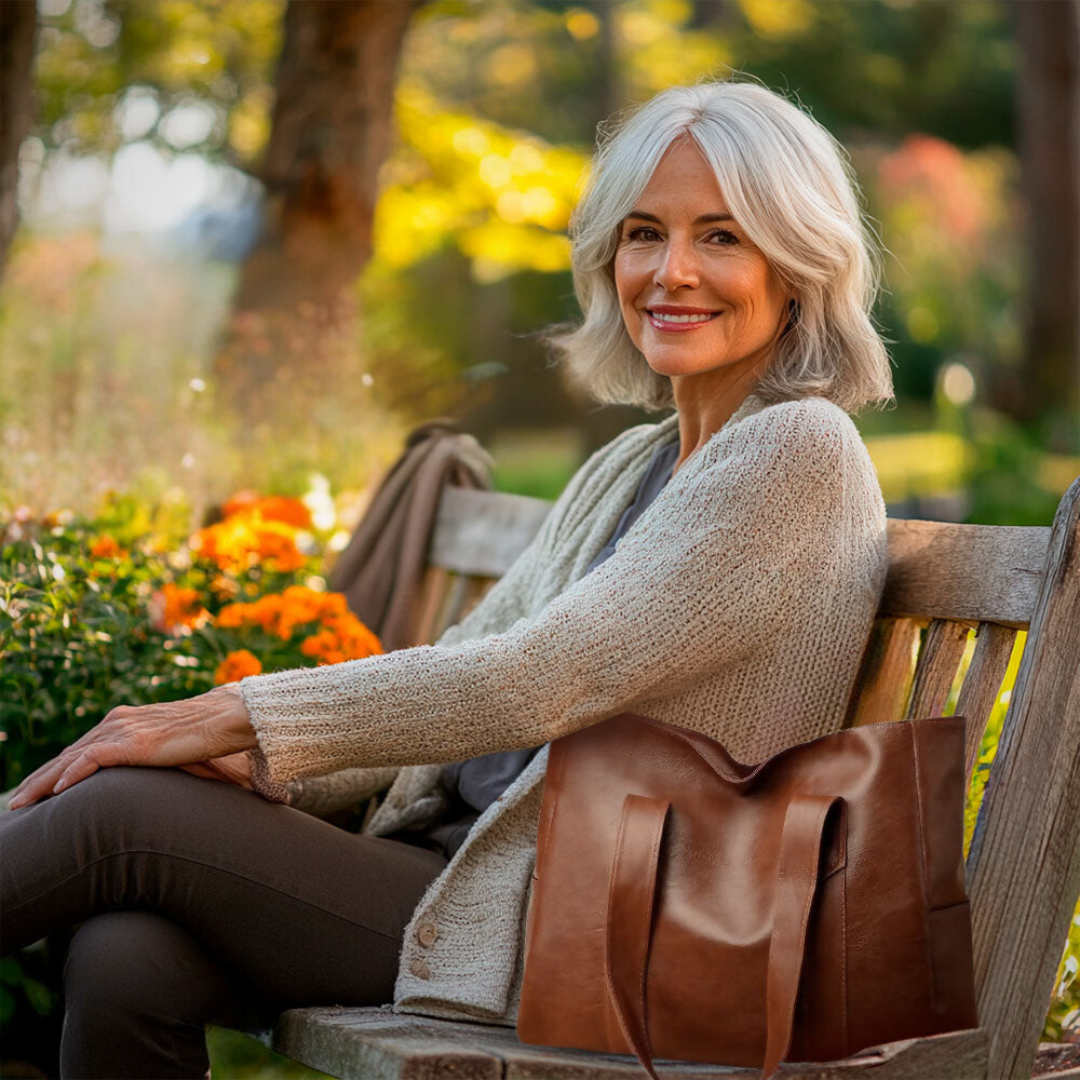 A woman carrying a classic elegant bag with a rich finish over her shoulder