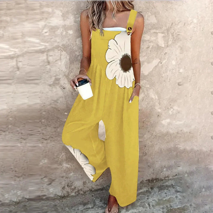 A woman wearing elegant black overalls with a single large cream bloom and adjustable straps.
