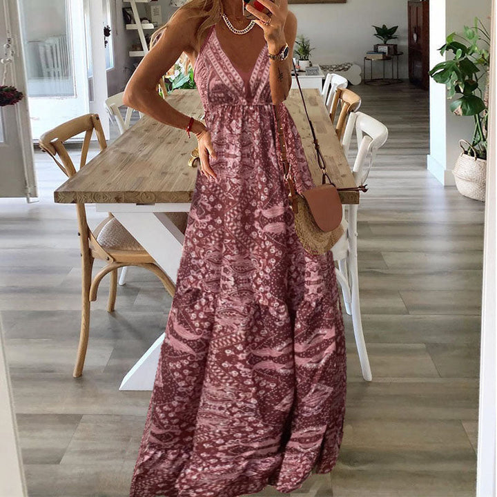 A woman wearing the Kelly sleeveless boho maxi dress with adjustable straps and a flowing tiered skirt.