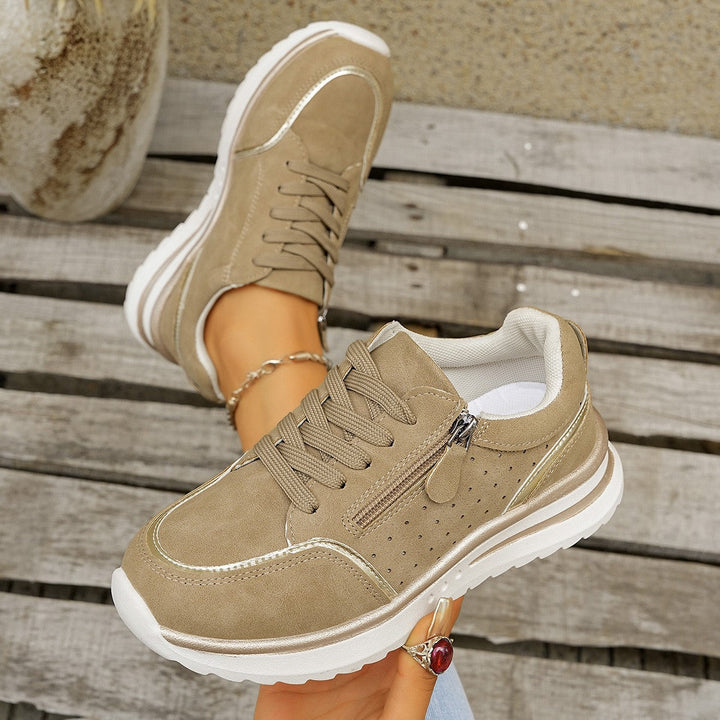 A woman standing comfortably in orthopaedic arch support sneakers.