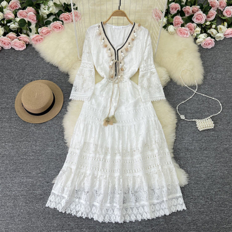 Woman twirling in the Genevieve romantic boho maxi dress with delicate floral detailing and a ruffled hem.