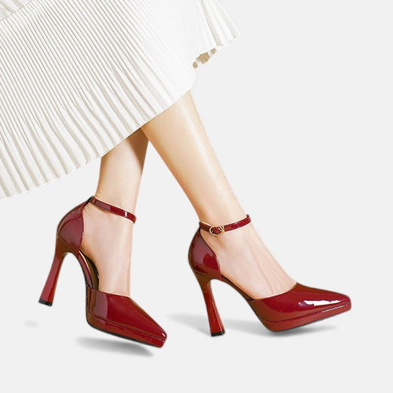 A woman in pointed ankle-strap pumps with a block heel, dressed for a day-to-night occasion.