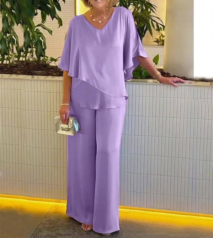A woman wearing an asymmetric flowing top with matching wide-leg pants.
