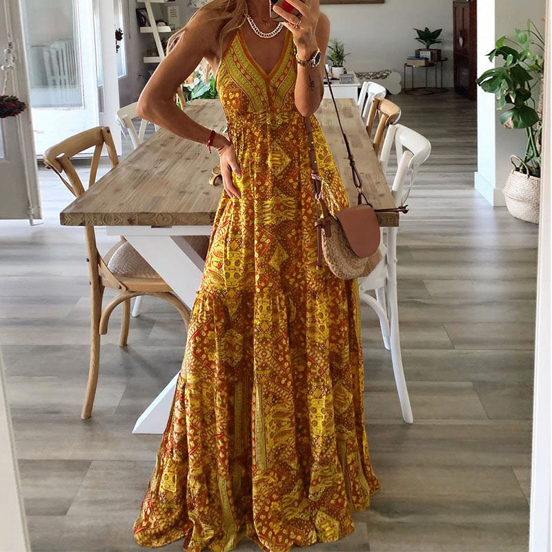 A woman wearing the Kelly sleeveless boho maxi dress with adjustable straps and a flowing tiered skirt.
