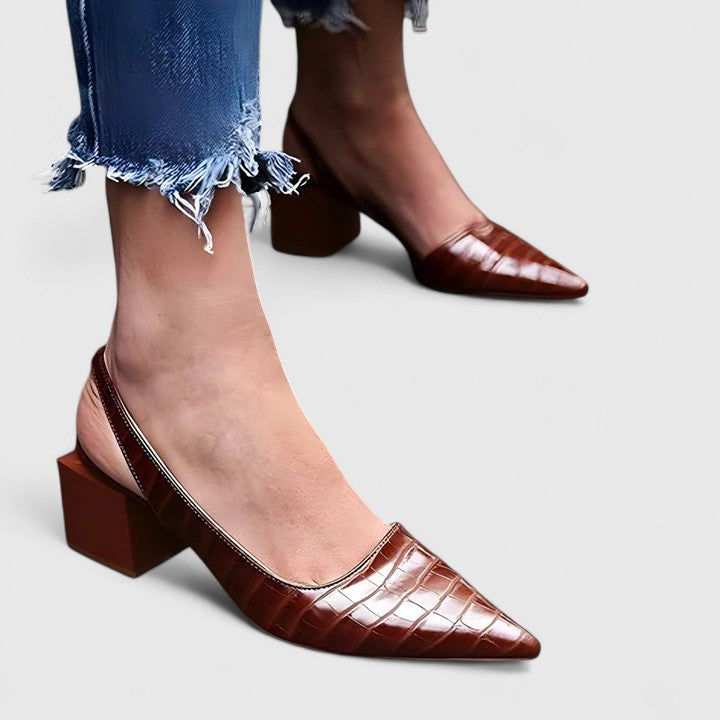 A glossy black croc-effect pointed-toe slingback with a low block heel, shown at an angle.