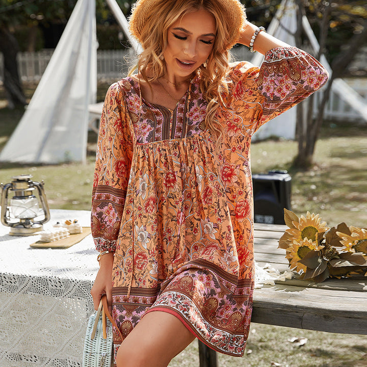 Woman relaxing outdoors in the Darlene boho tunic dress with a vivid floral print.