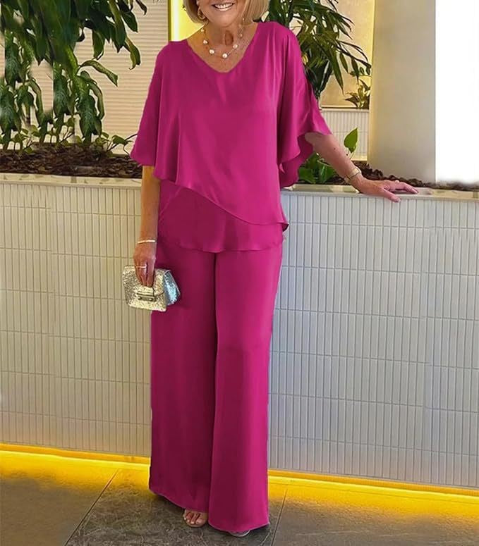 A woman wearing an asymmetric flowing top with matching wide-leg pants.