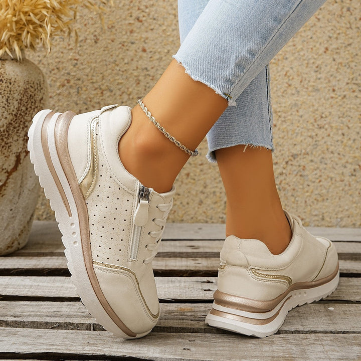 A woman standing comfortably in orthopaedic arch support sneakers.