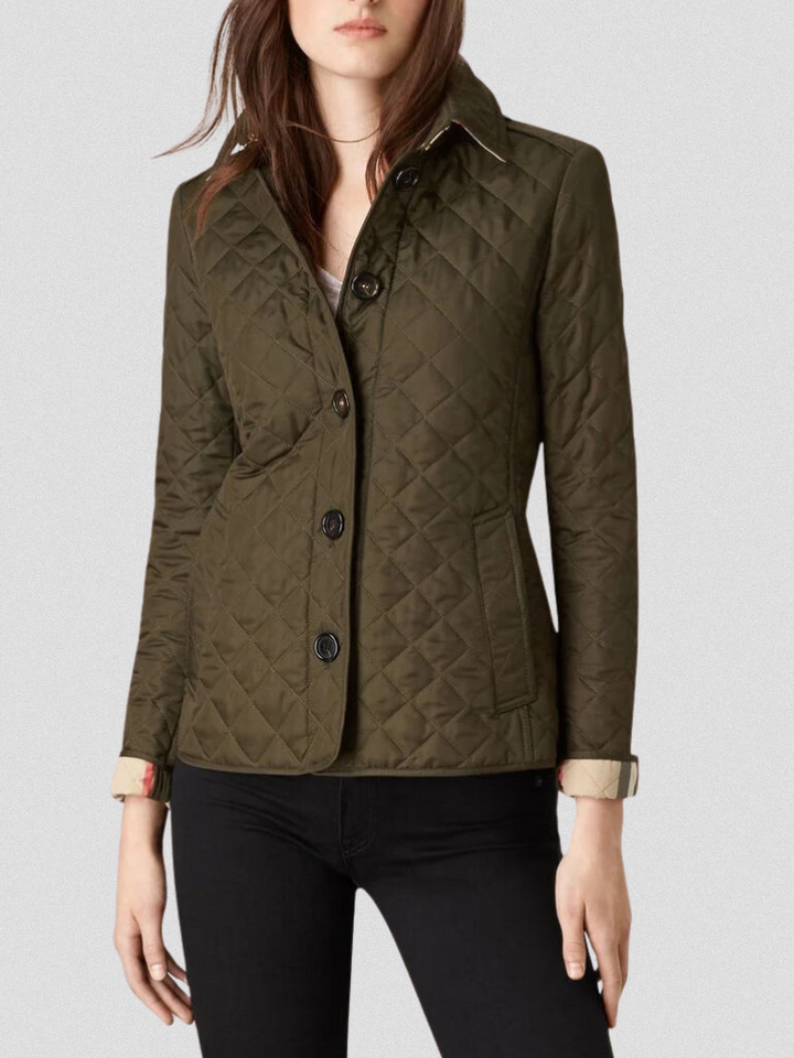 A woman wearing an fall jacket over a top, layered for a crisp day in town.