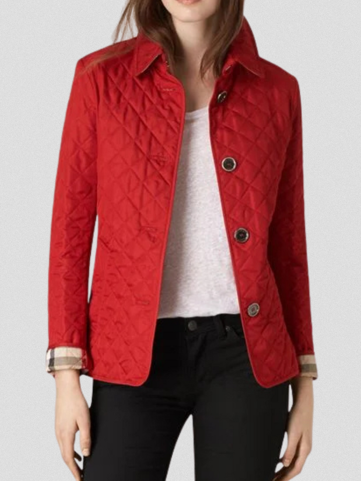 A woman wearing an fall jacket over a top, layered for a crisp day in town.