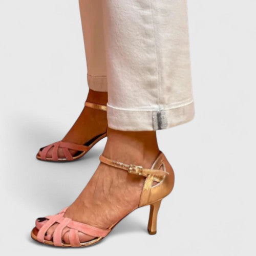 A woman wearing T-strap orthopaedic heels, stepping out with confidence in an elegant outfit.