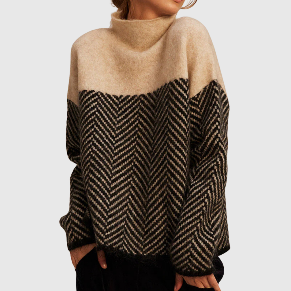 A woman wearing a zigzag-pattern funnel neck sweater styled elegantly for an fall day out.