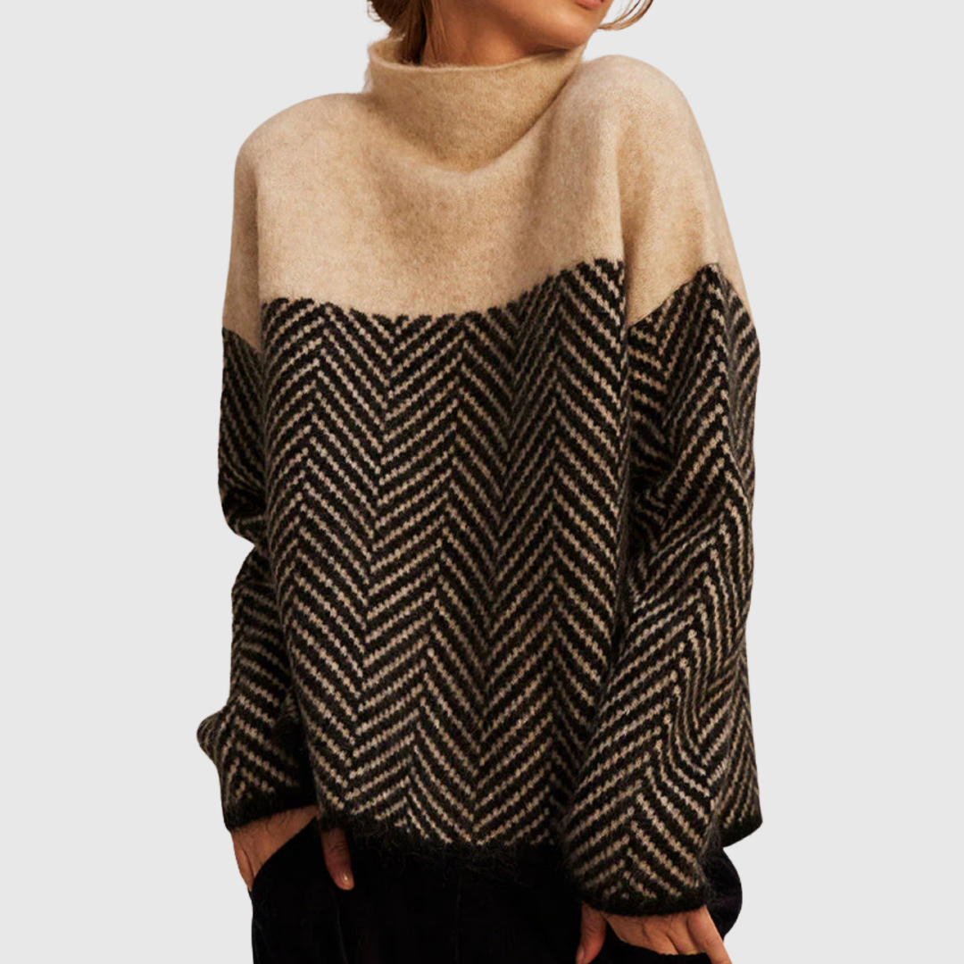A woman wearing a zigzag-pattern funnel neck sweater styled elegantly for an fall day out.